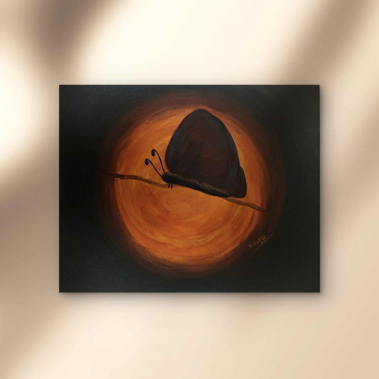 Butterfly painting on a wall with warm lighting