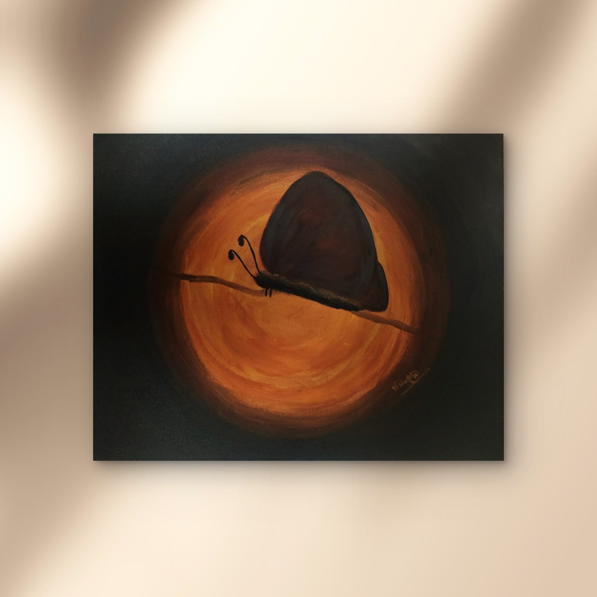 Butterfly painting on a wall with warm lighting