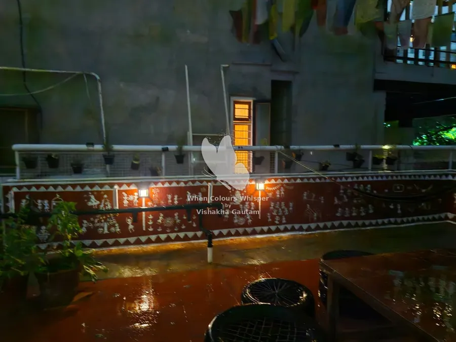 Warli terrace mural at night