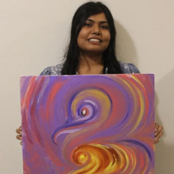 Vishakha Gautam holding one of her paintings