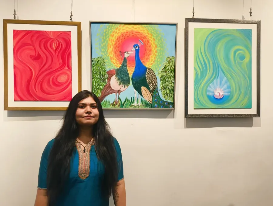 Vishakha Gautam with her paintings at an exhibition